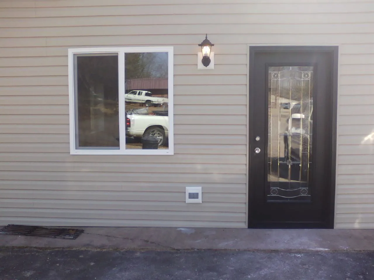 New siding, window and entry door on the side of an addition in Armstrong Creek